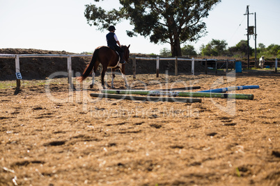 Boy riding a horse in the ranch