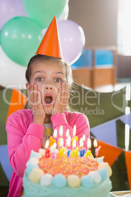 Birthday girl with cake at home