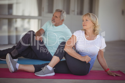 Senior couple performing stretching exercise