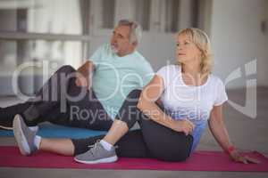 Senior couple performing stretching exercise