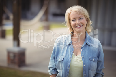 Senior woman smiling outside her house