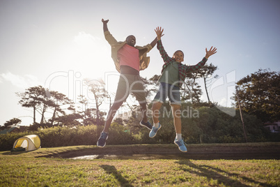 Father and son jumping in the park