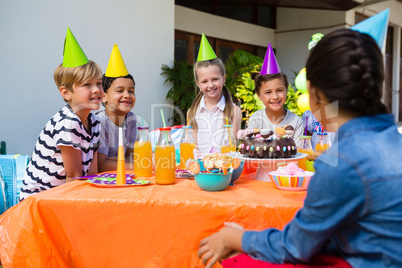 Friends talking during birthday party