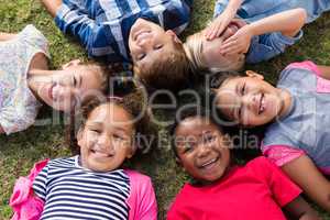 Directly above portrait of children lying on field
