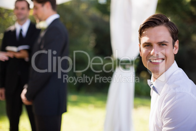 Portrait of happy waiter in park