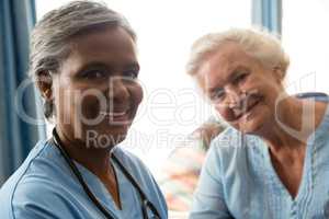 Portrait of happy nurse and senior woman