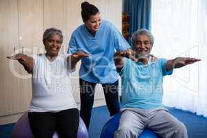Nurse guiding seniors in exercising