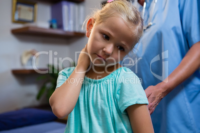 Female doctor examining a little girl