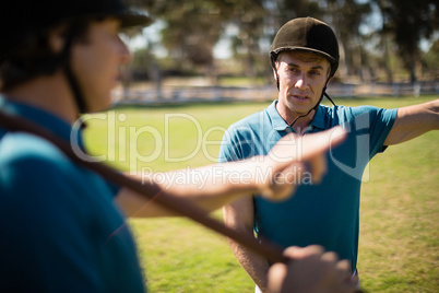 Tow male jockey talking to each other