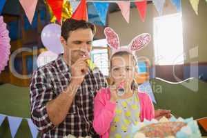 Father and daughter celebrating birthday at home