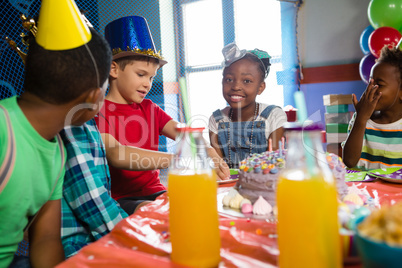 Happy children sitting at table