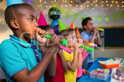 Children blowing party horns