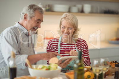 Senior couple using digital tablet