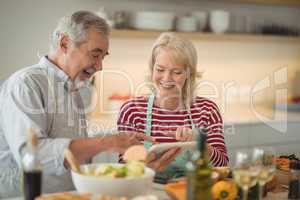 Senior couple using digital tablet