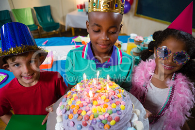 High angle view of boy holding birthday cake