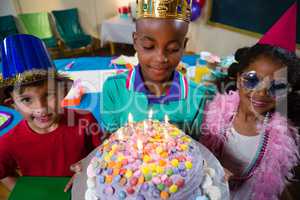 High angle view of boy holding birthday cake