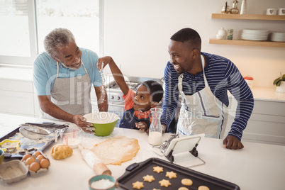 Boy playing with the flour while preparing cookies