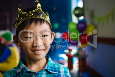 Portrait of boy wearing crown