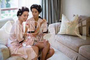 Bride and her friend applying cosmetics