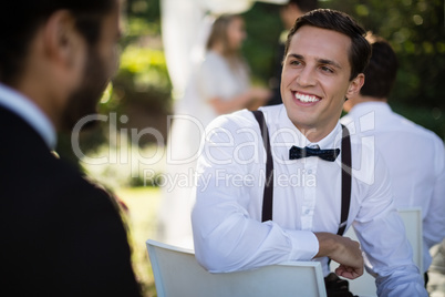 Waiter interacting with man in park