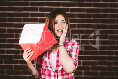 Surprise woman holding envelope