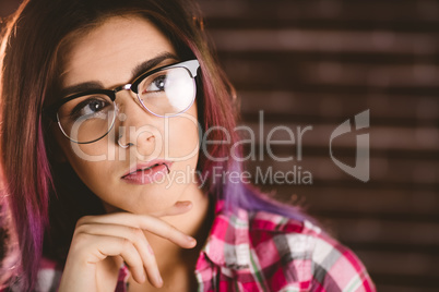 Thoughtful woman in spectacles