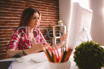 Frustuated woman looking at desktop computer