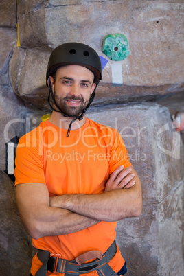 Trainer standing with arms crossed in fitness studio