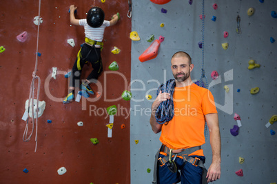 Trainer standing with rope in fitness studio