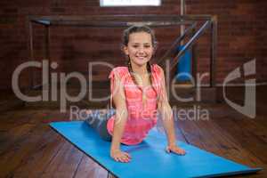 Portrait of happy teenage girl practicing yoga