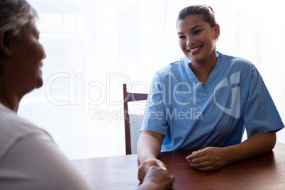 Nurse interacting with senior woman in retirement home