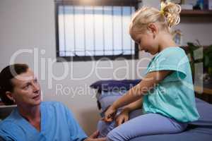 Female doctor examining a little girl