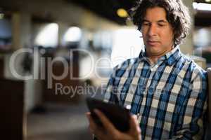 Man using digital tablet in the stable