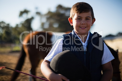 Boy smiling at camera in the ranch