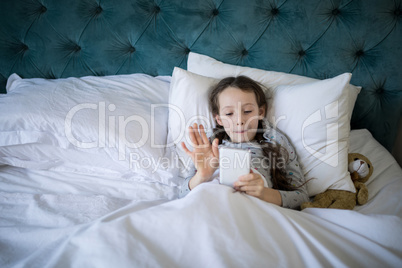 Girl video calling on mobile phone in bedroom