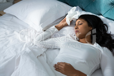 Sick woman sleeping on bed