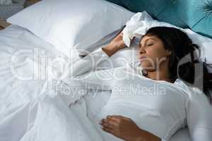 Sick woman sleeping on bed