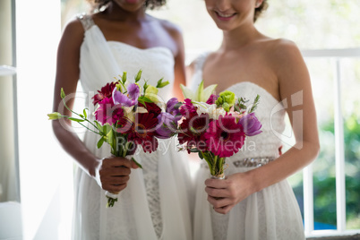 Bride and bridesmaids standing with bouquet