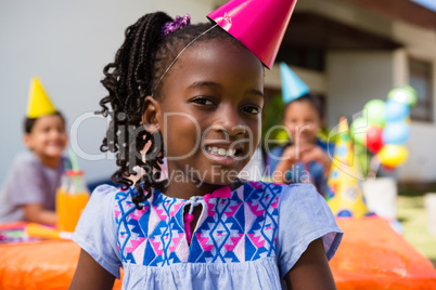 Close up portrait of girl with friends in background