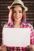 Portrait of smiling woman holding blank sheet