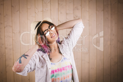 Woman posing with her hands behind her head