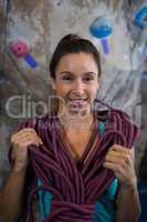 Happy woman with rope in fitness studio