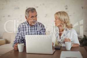 Senior couple using laptop