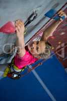 Portrait of teenage girl practicing rock climbing