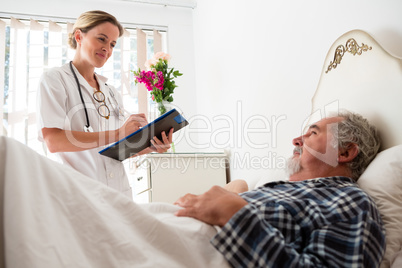 Doctor examining male patient in nursing home