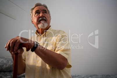 Thoughtful senior man standing outdoors during foggy weather