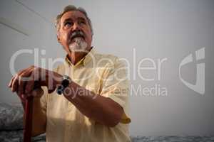 Thoughtful senior man standing outdoors during foggy weather