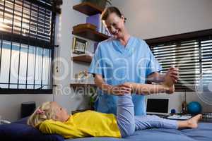 Physiotherapist giving physical therapy to the girl