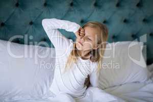 Girl waking up on bed in bedroom