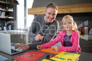 Father and daughter posing while coloring